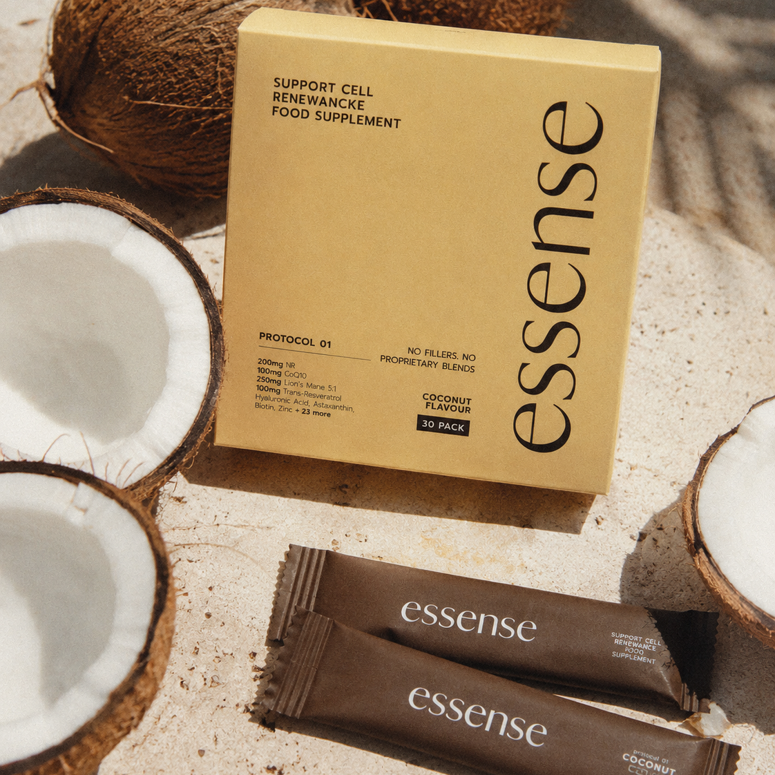 Protocol 01 sachet box and two sachets beside fresh coconut halves · coconut flavour daily longevity base · Essense